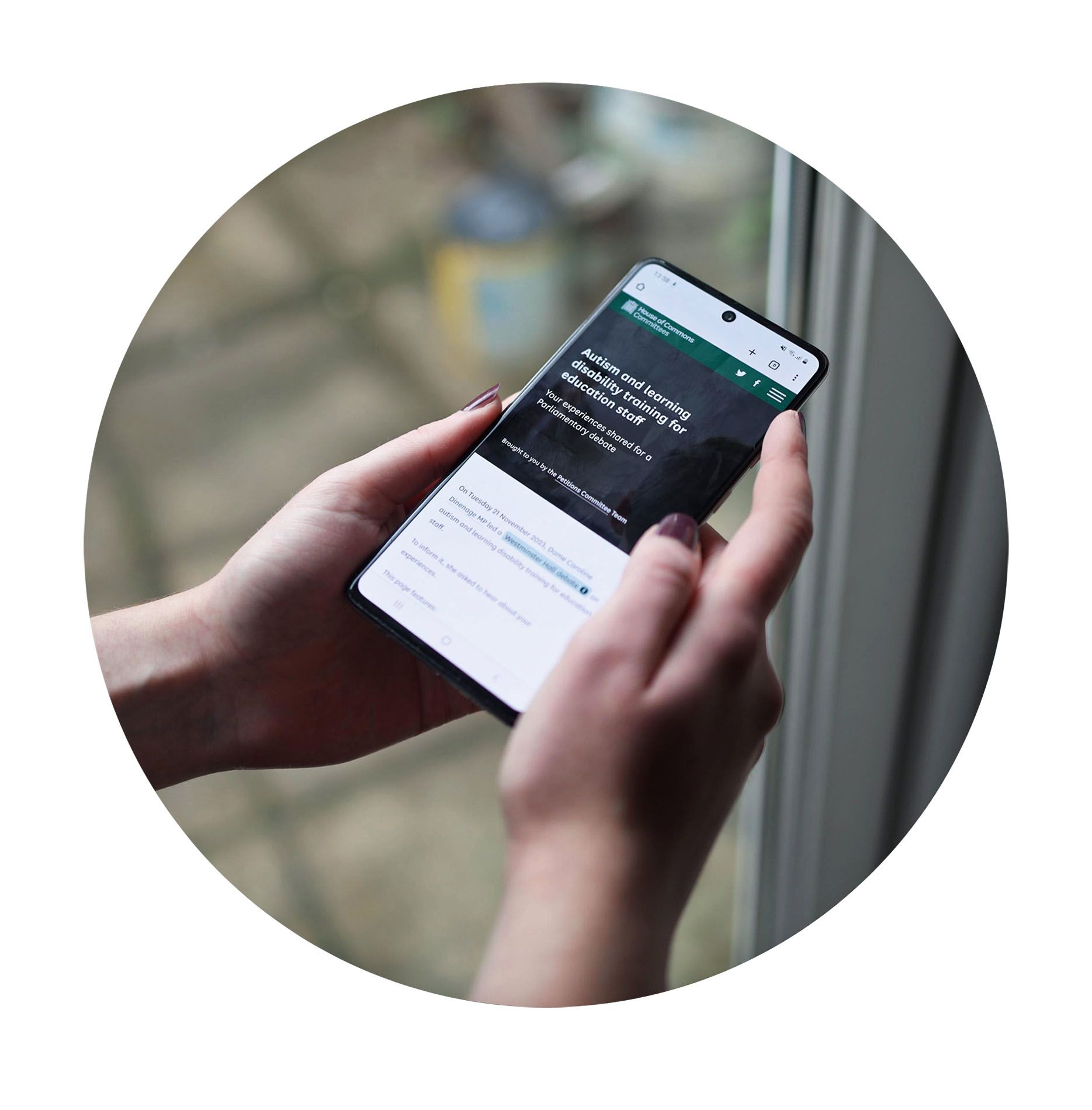 Hands holding phone scrolling through webpage