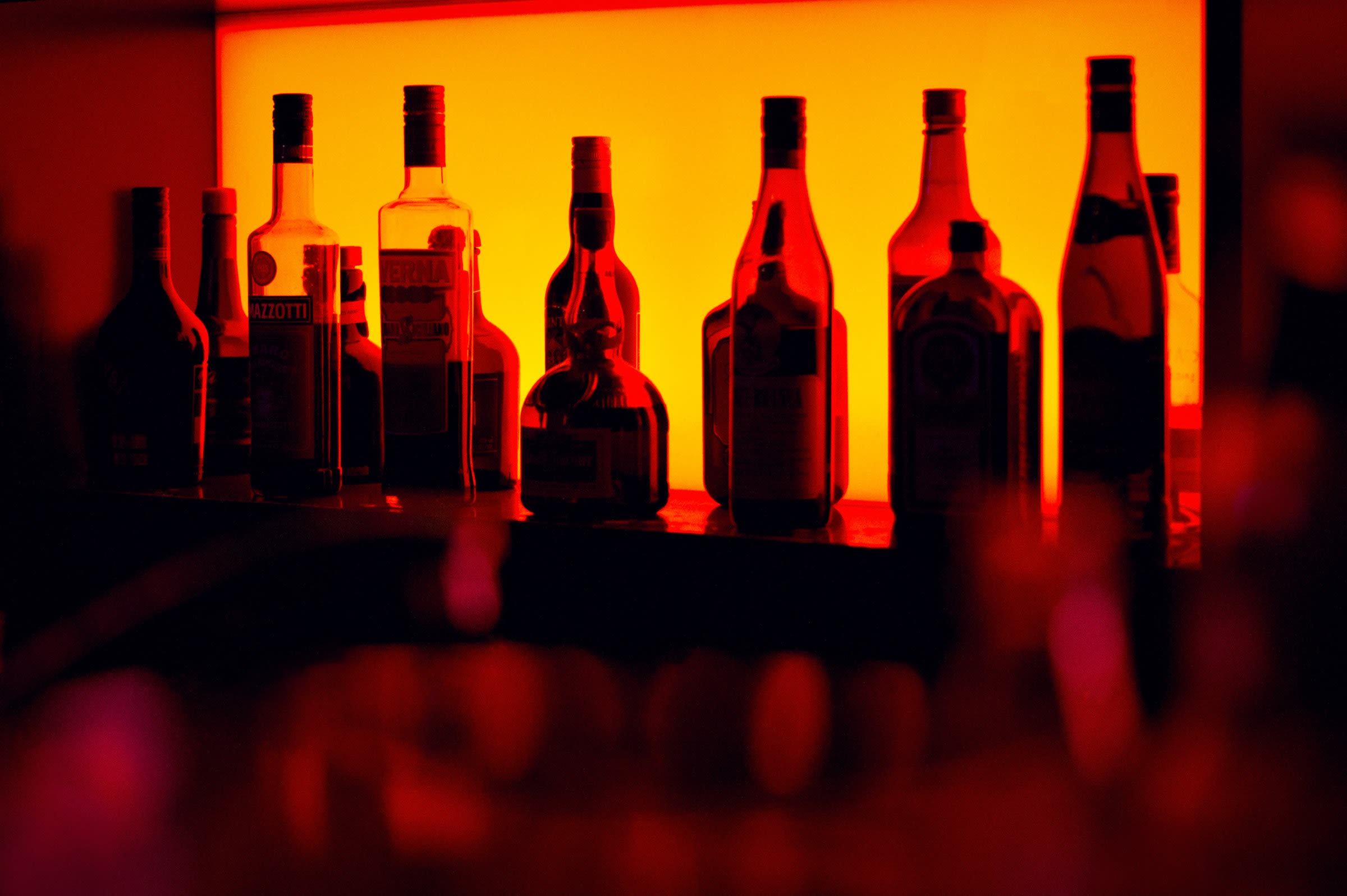 Photo of bottles lined up behind a bar