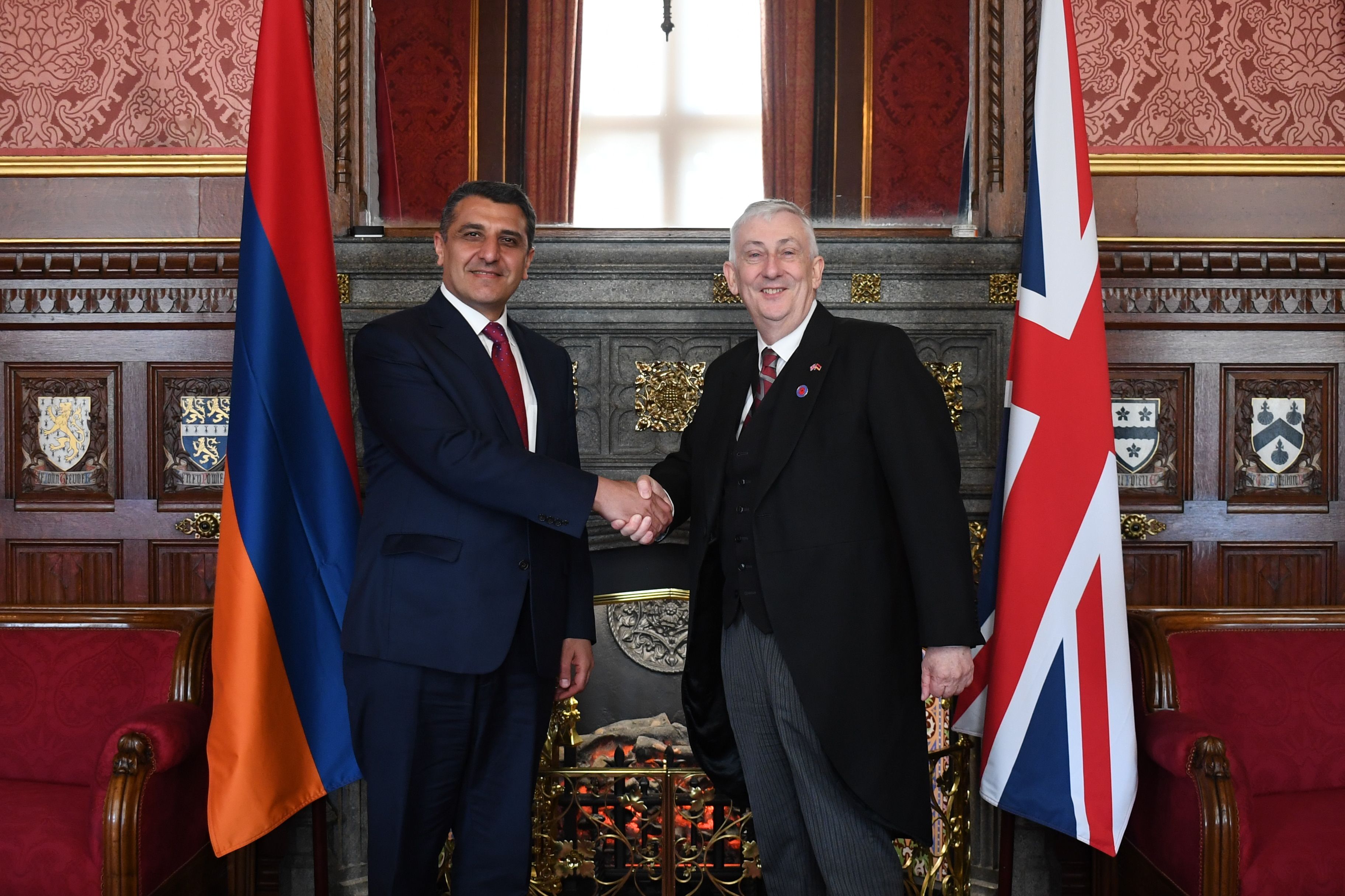 Speaker shaking hands with Ambassador