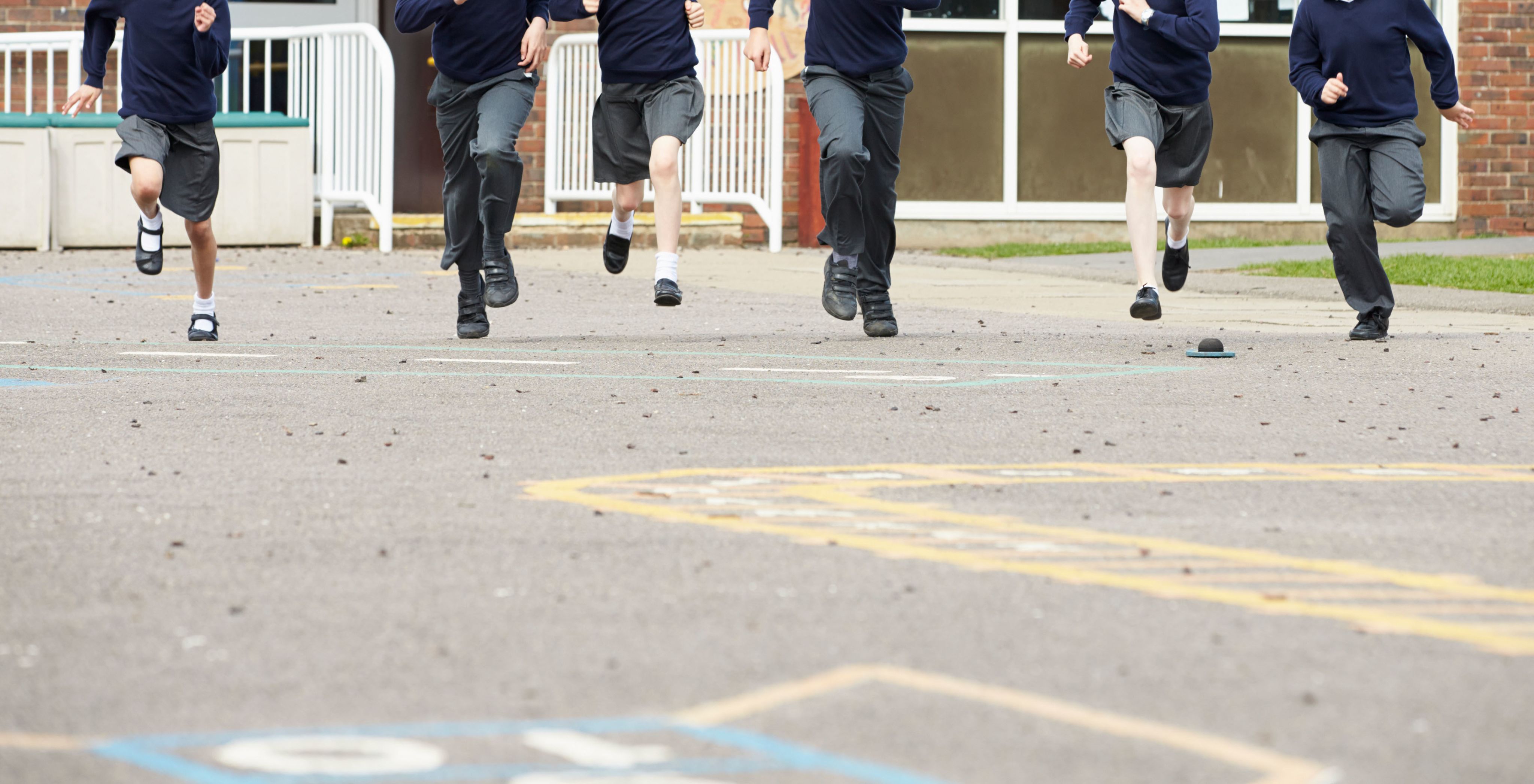 Children running across a playground.