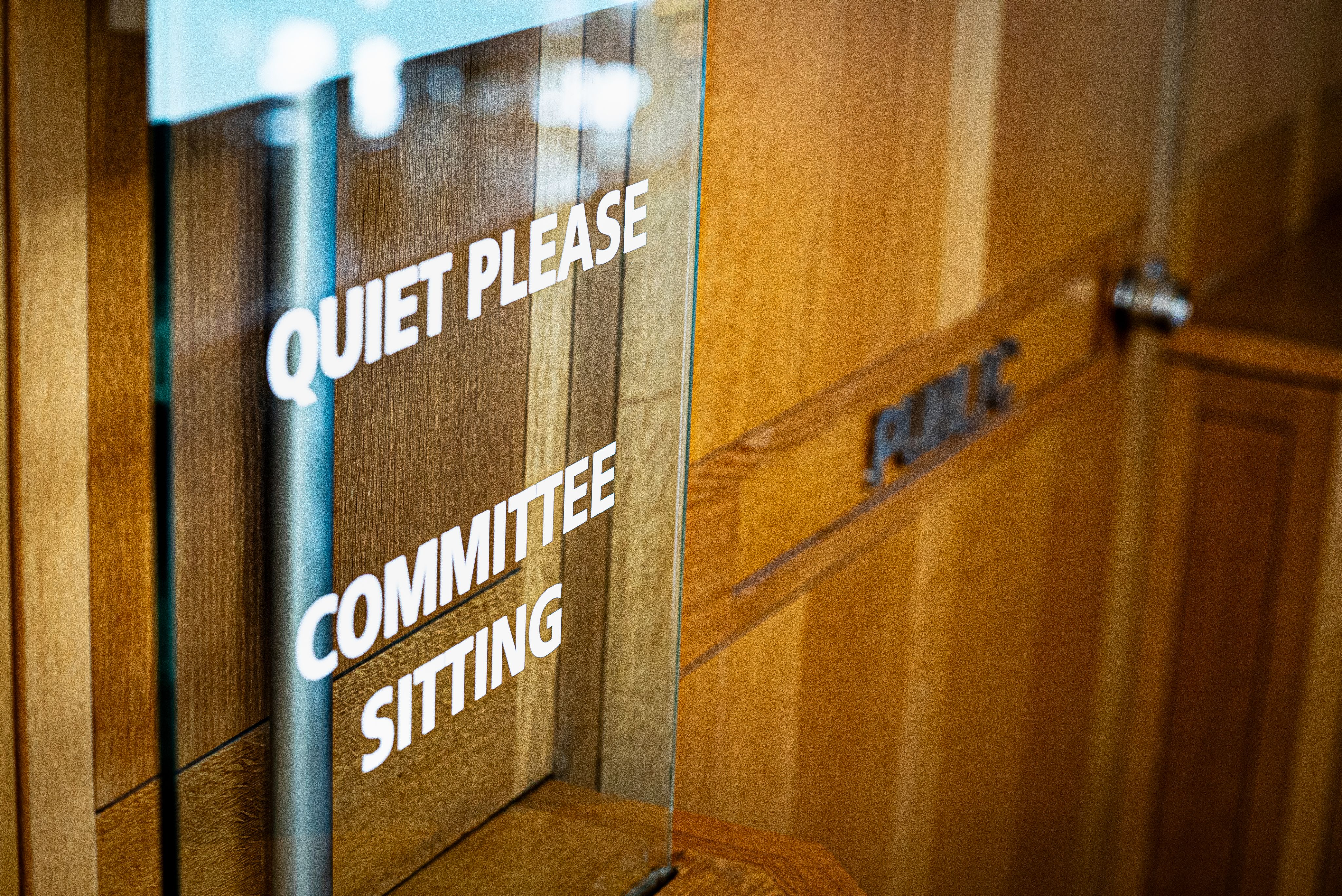 Sign outside of House of Commons committee room that reads "Quiet please. Committee sitting."