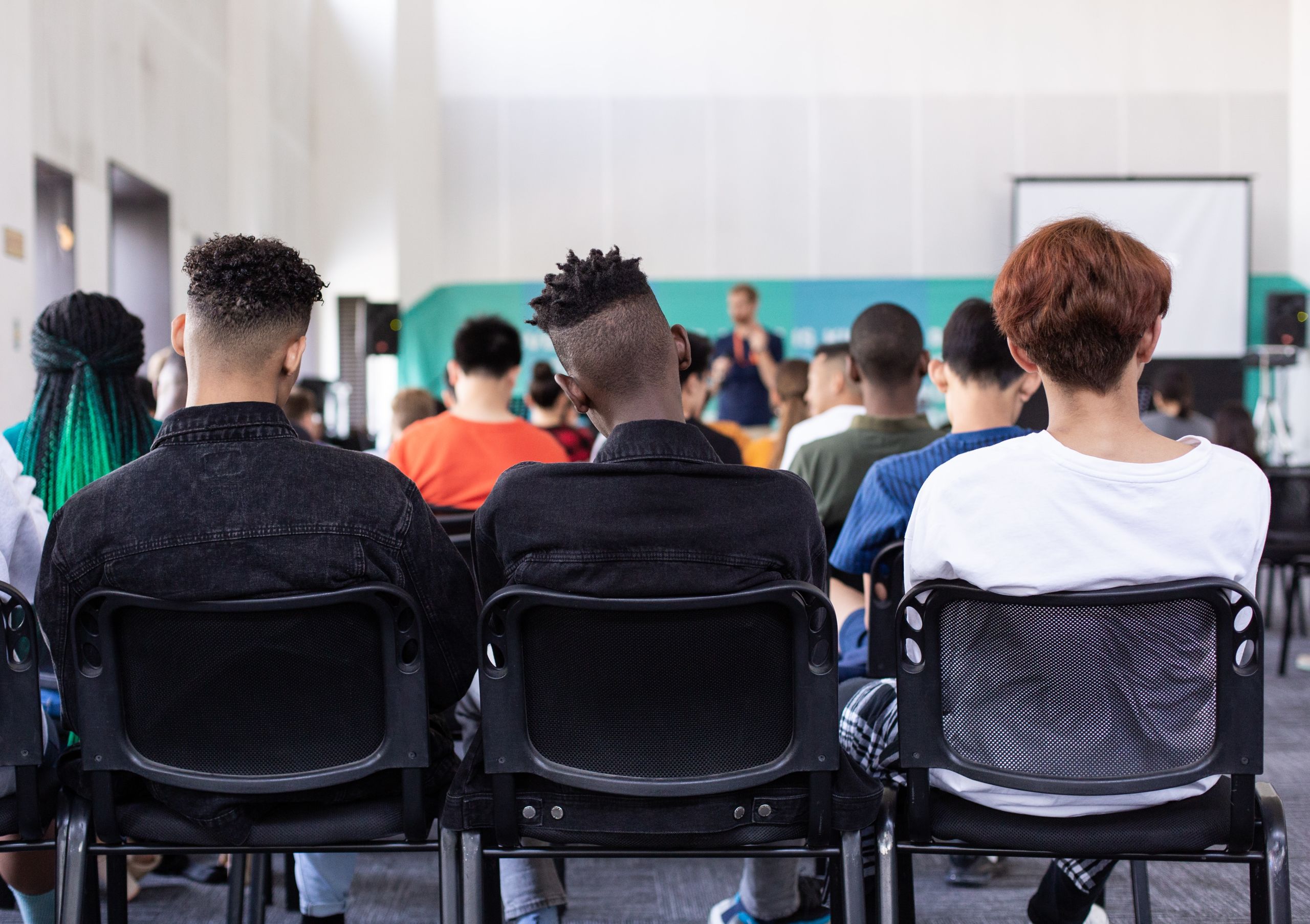 Three teenage students in a classroom. 