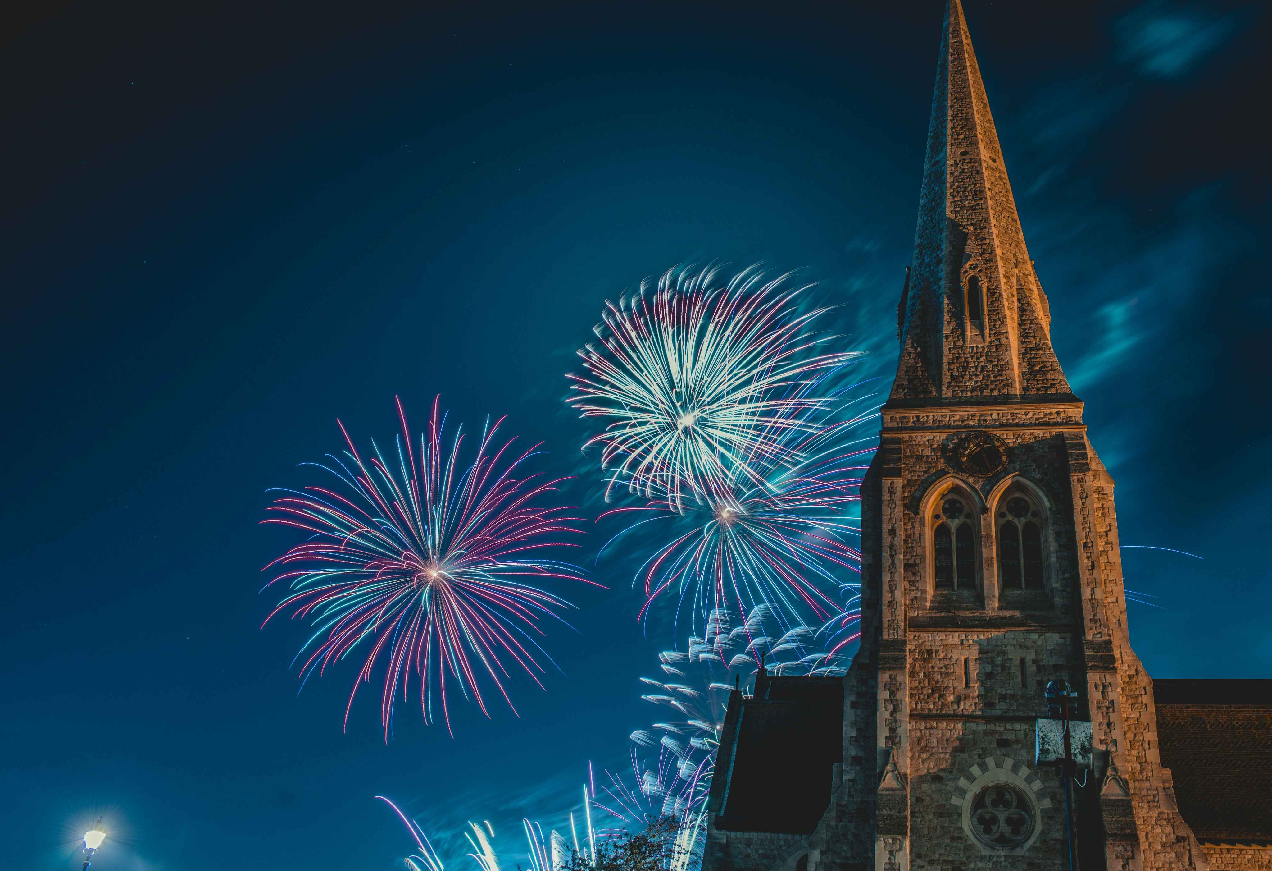 photo of pointed-edge church with fireworks