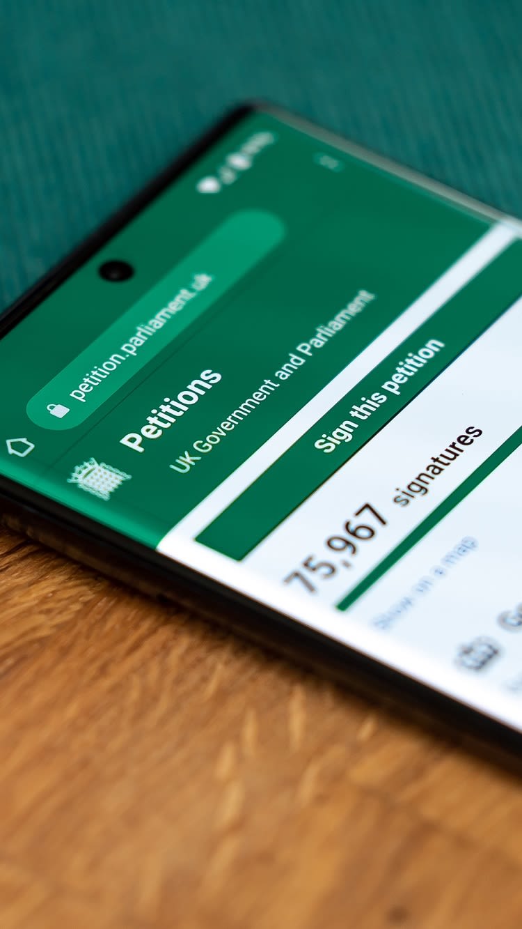 Image on smartphone with petition.parliament.uk open.