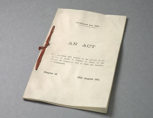 The Act is on aged paper, tied on the left with red ribbon. It says 'Parliament Act 1911' at the top, and AN ACT in the centre of the page. There is a smaller text summary underneath