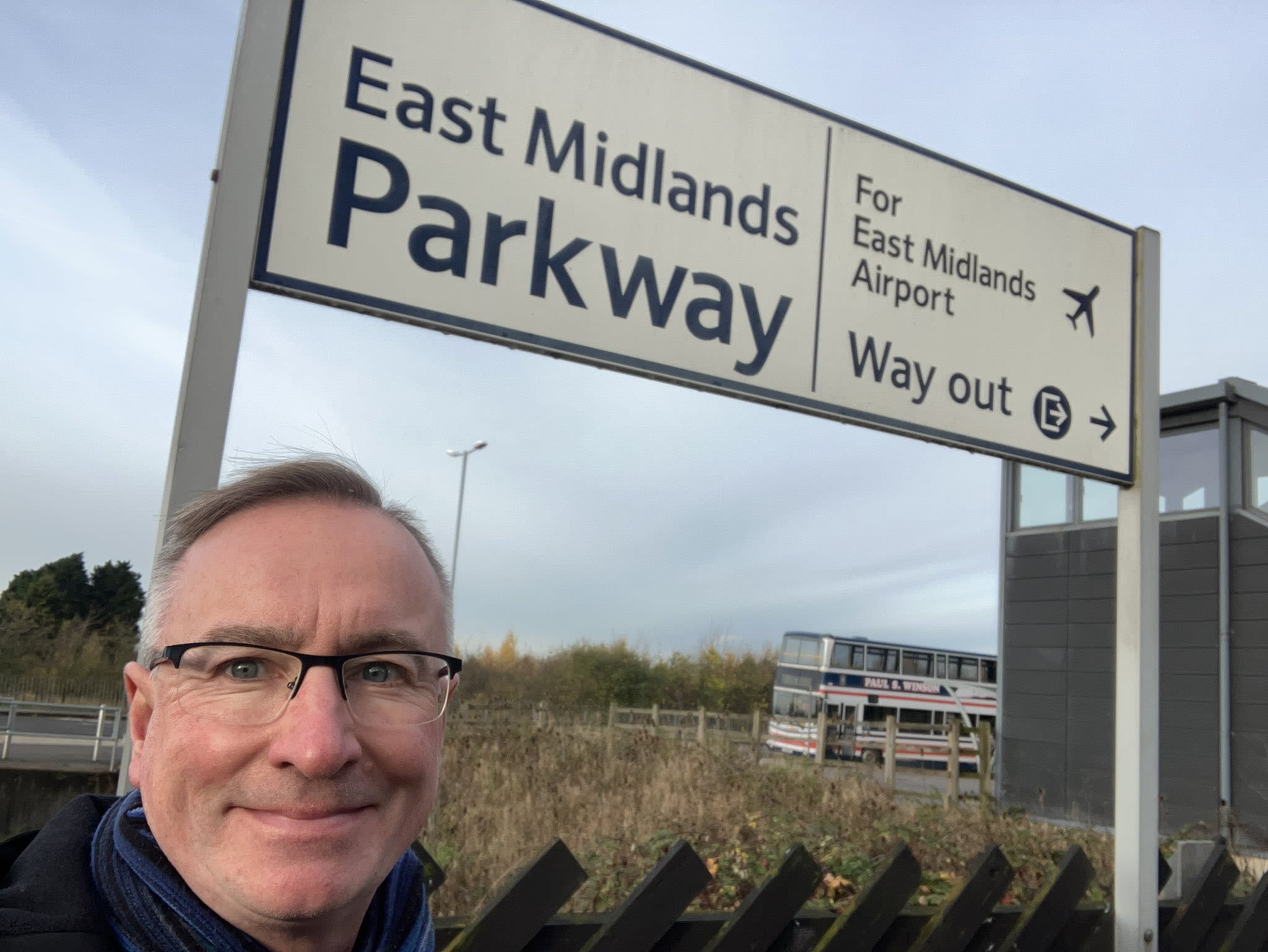An image of the East Midlands officer by a train sign for "East Midlands Parkway"