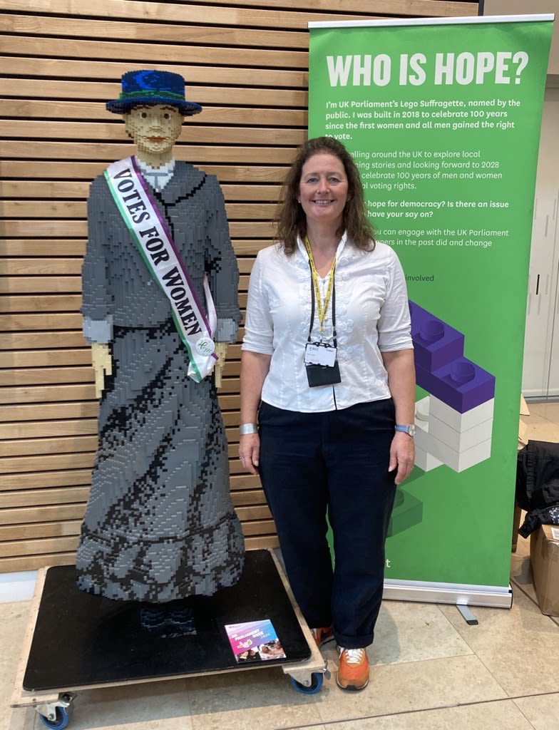 A photograph of our South East Officer with a Lego suffragette 