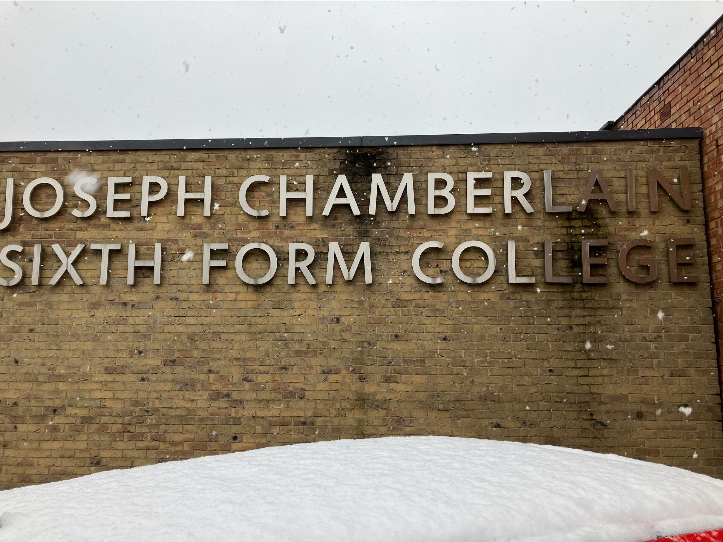 A photograph of a sixth form college with snow falling